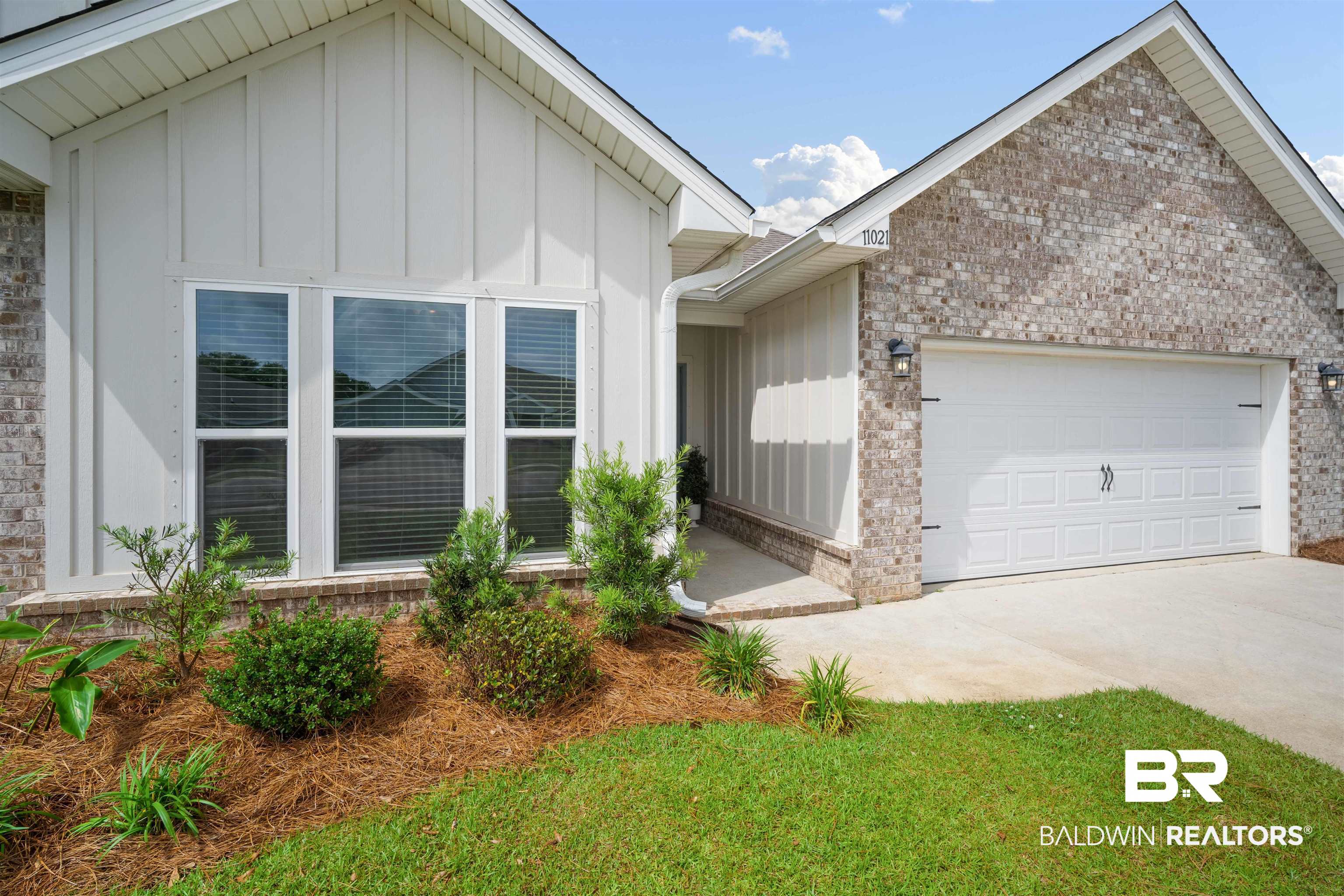 11021 Native Dancer Way Daphne, AL 36526 - Photo 3 of 35 View of front of property featuring concrete driveway, brick siding, board and batten siding, and a garage