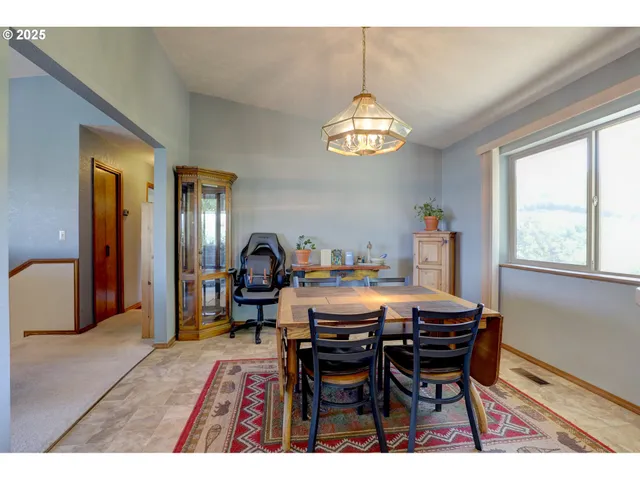 a view of a dining room with furniture a chandelier and wooden floor
