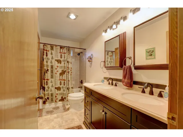 a bathroom with a sink mirror and a shower