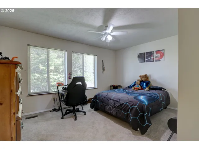 a bedroom with a bed and a large window