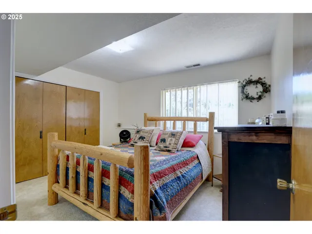 a bedroom with bed and a window