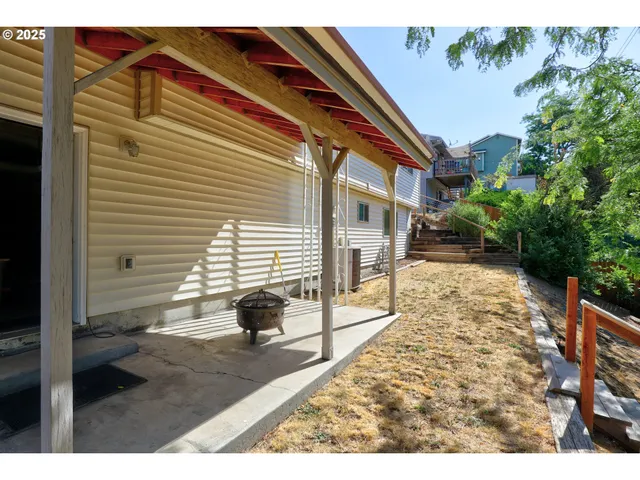a view of a backyard with sitting area