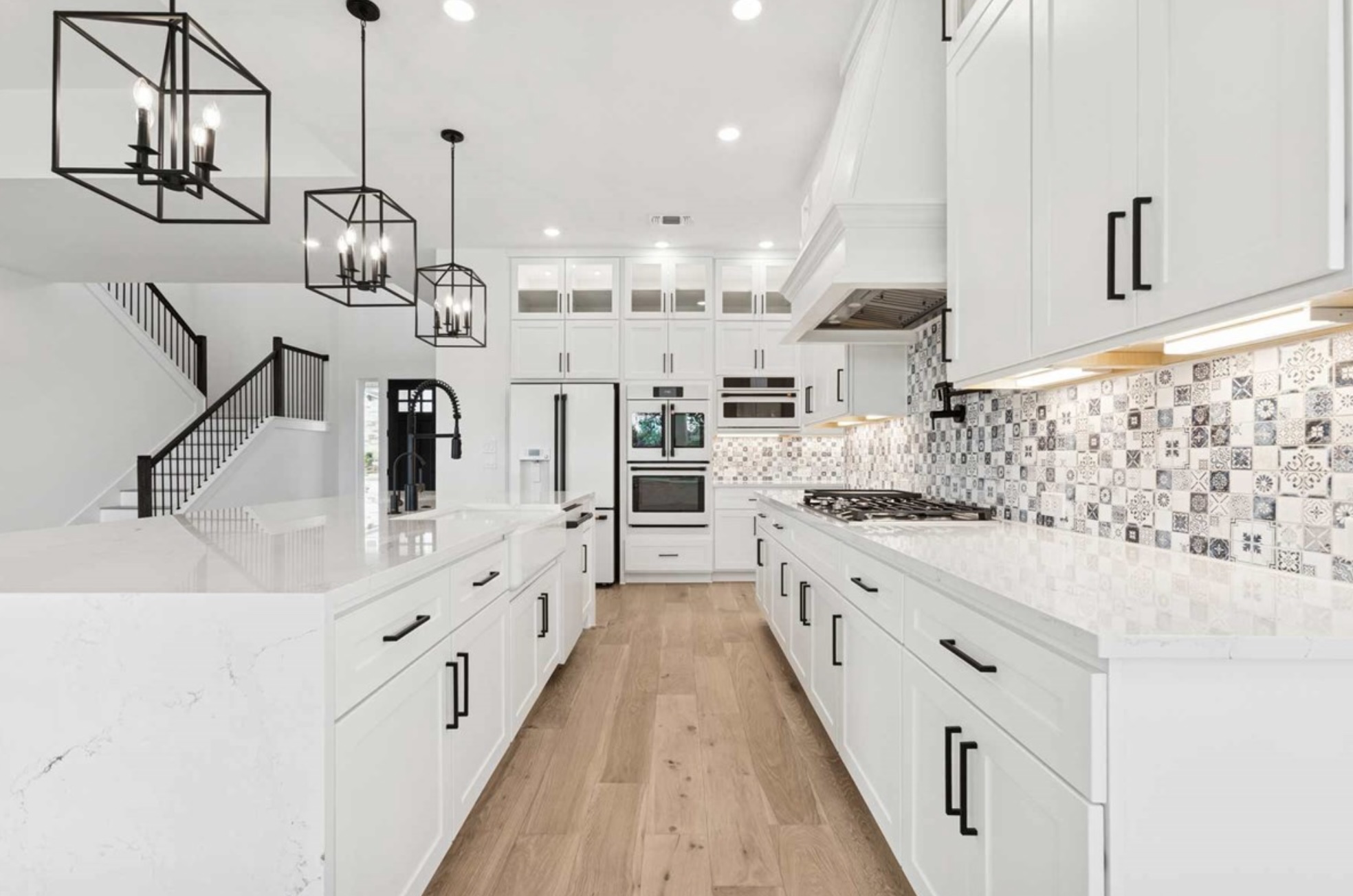 439 Vail River Road Dripping Springs, TX 78620 - Photo 5 of 20 a large white kitchen with kitchen island stainless steel appliances sink and cabinets