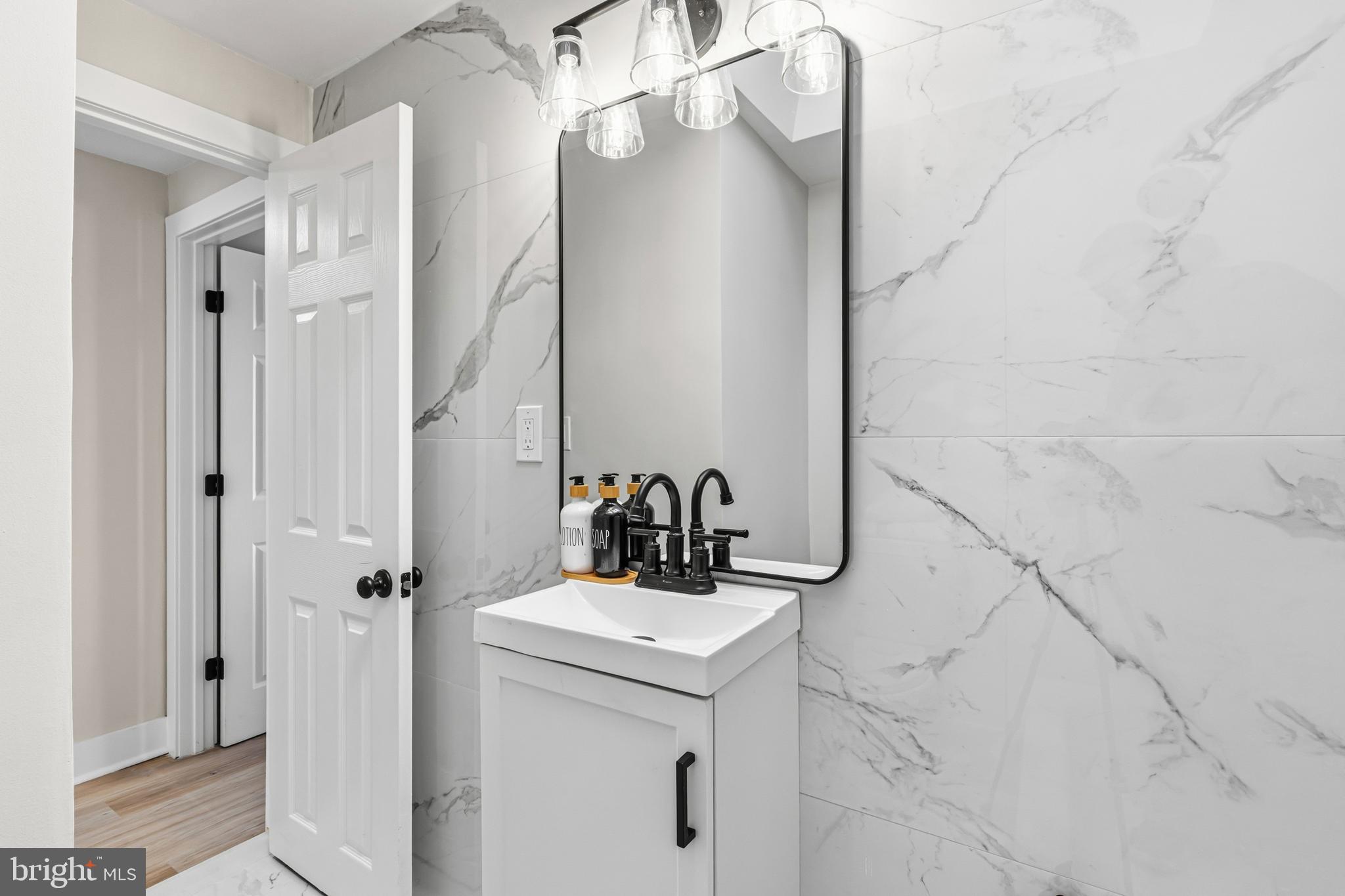 726 Grant Road Folcroft, PA 19032 - Photo 13 of 23 a bathroom with a sink vanity and a mirror