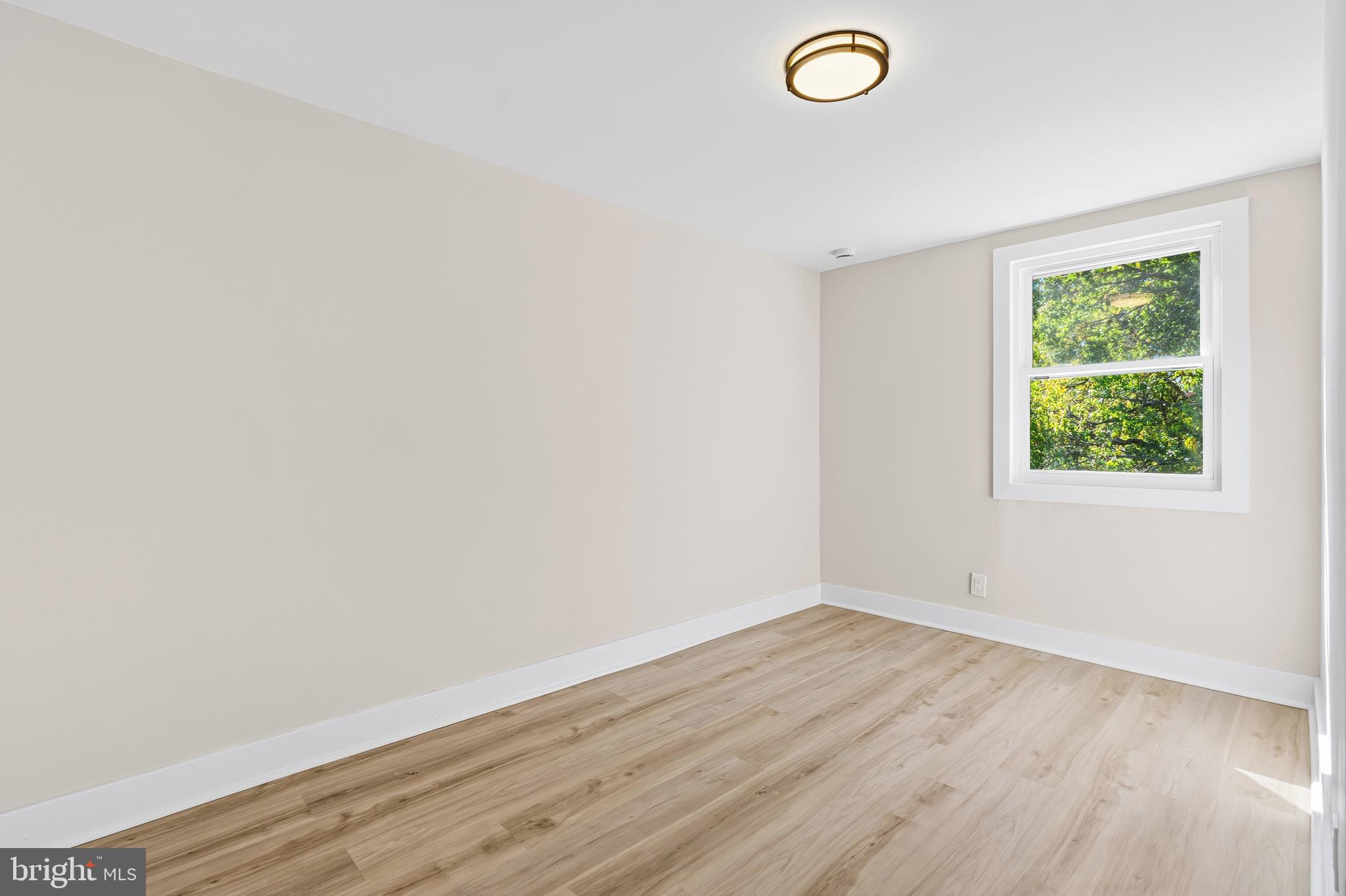 726 Grant Road Folcroft, PA 19032 - Photo 16 of 23 an empty room with wooden floor and windows