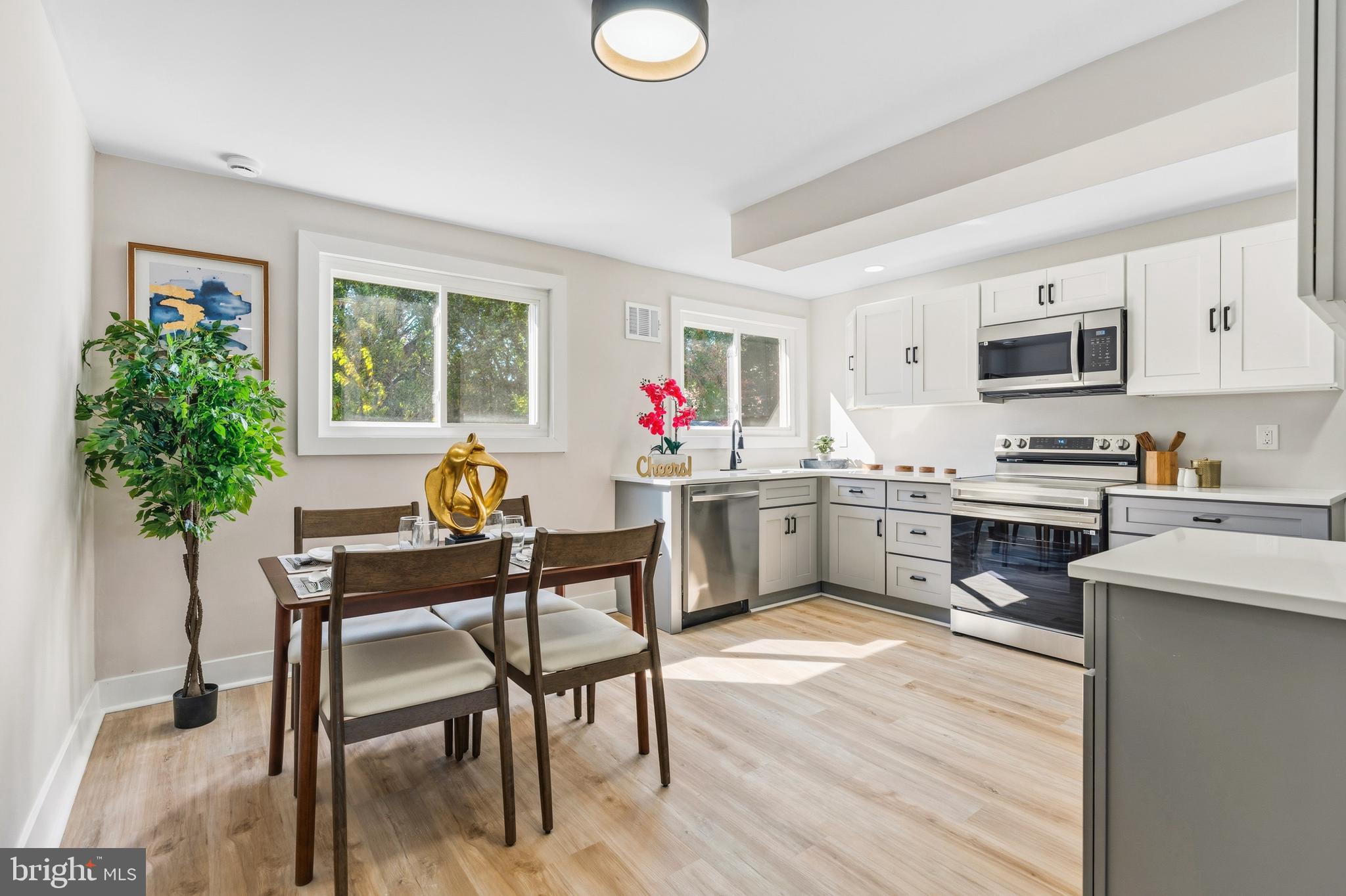 726 Grant Road Folcroft, PA 19032 - Photo 6 of 23 a kitchen view with microwave a stove and chairs