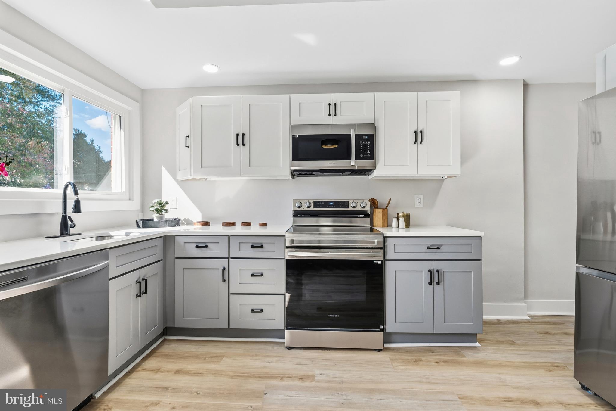 726 Grant Road Folcroft, PA 19032 - Photo 9 of 23 a kitchen with stainless steel appliances granite countertop a stove sink and cabinets