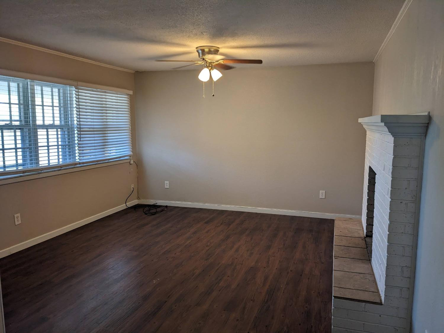4009 44th Street Lubbock, TX 79413 - Photo 13 of 15 an empty room with wooden floor fan and windows
