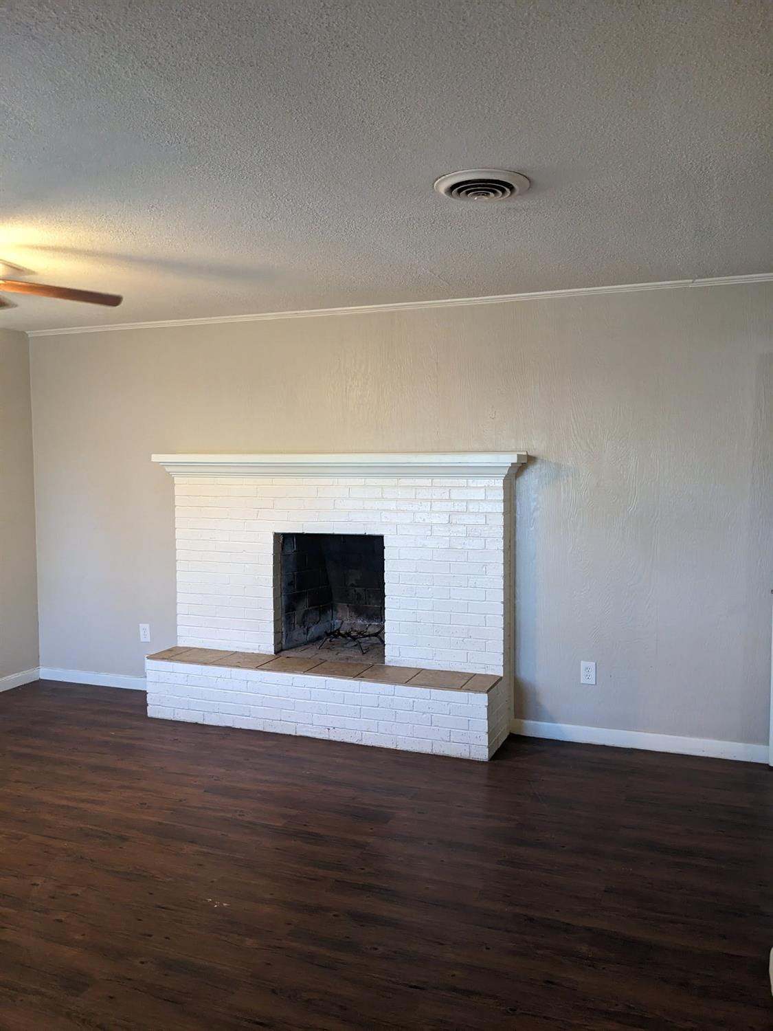 4009 44th Street Lubbock, TX 79413 - Photo 14 of 15 a view of empty room with wooden floor and fireplace