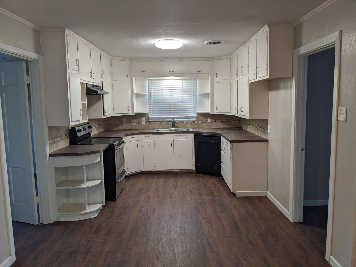 4009 44th Street Lubbock, TX 79413 - Photo 4 of 15 a kitchen with granite countertop a sink stove and refrigerator