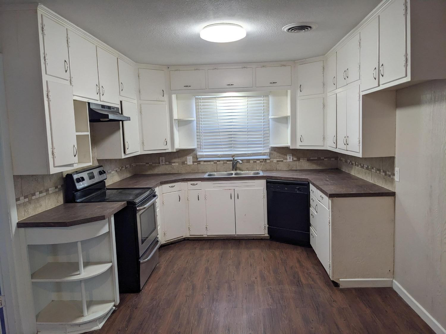 4009 44th Street Lubbock, TX 79413 - Photo 5 of 15 a kitchen with a sink stove and cabinets