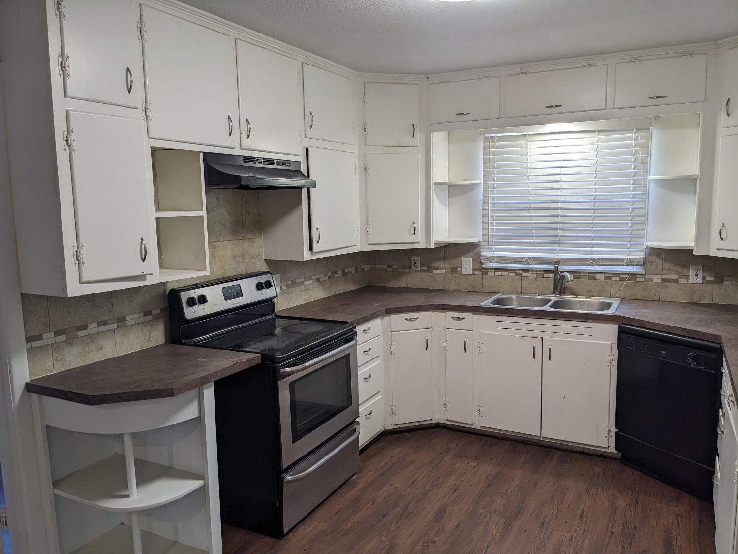4009 44th Street Lubbock, TX 79413 - Photo 6 of 15 a kitchen with granite countertop cabinets stainless steel appliances and a sink