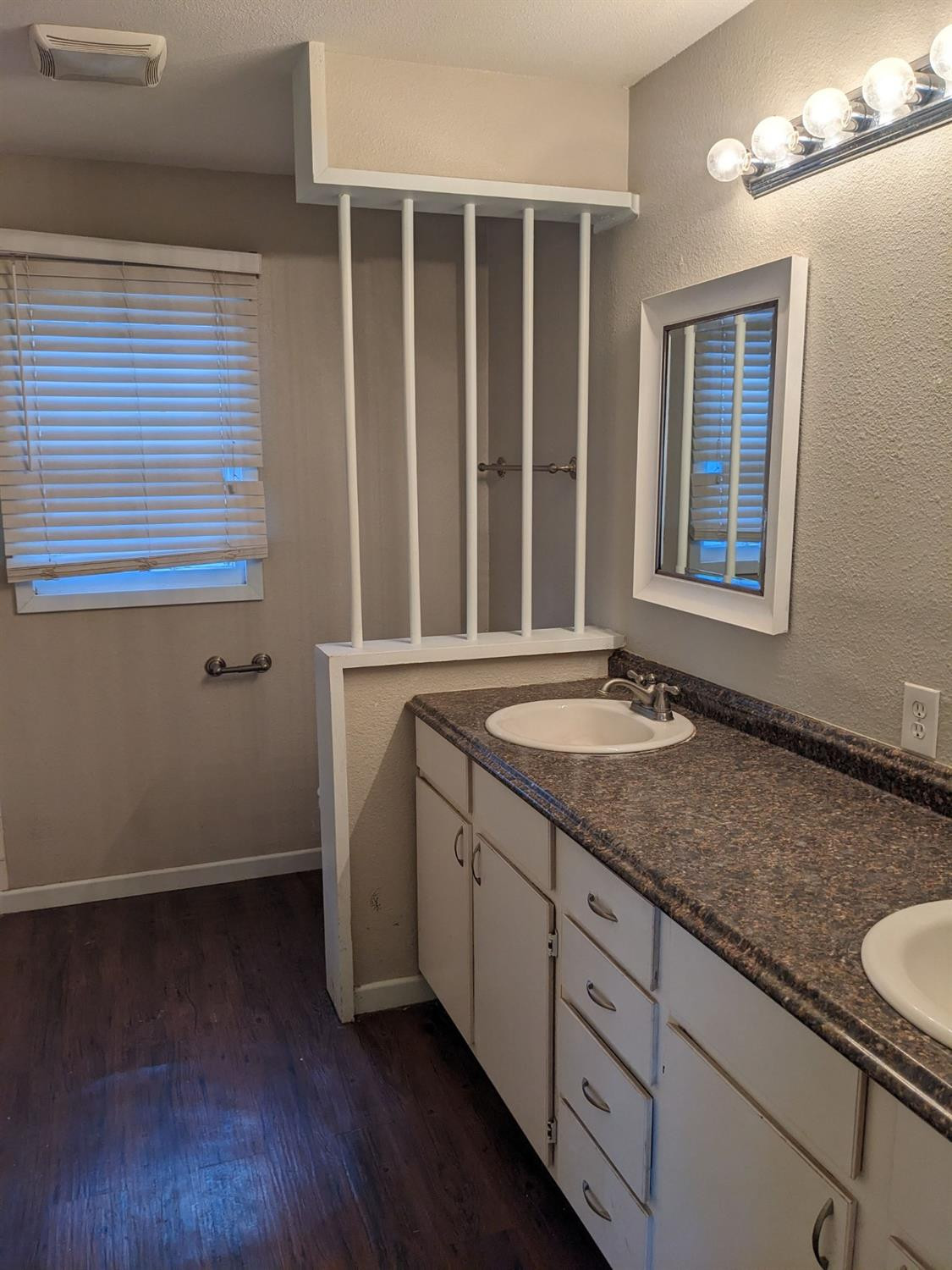 4009 44th Street Lubbock, TX 79413 - Photo 10 of 15 a bathroom with a granite countertop sink and a mirror