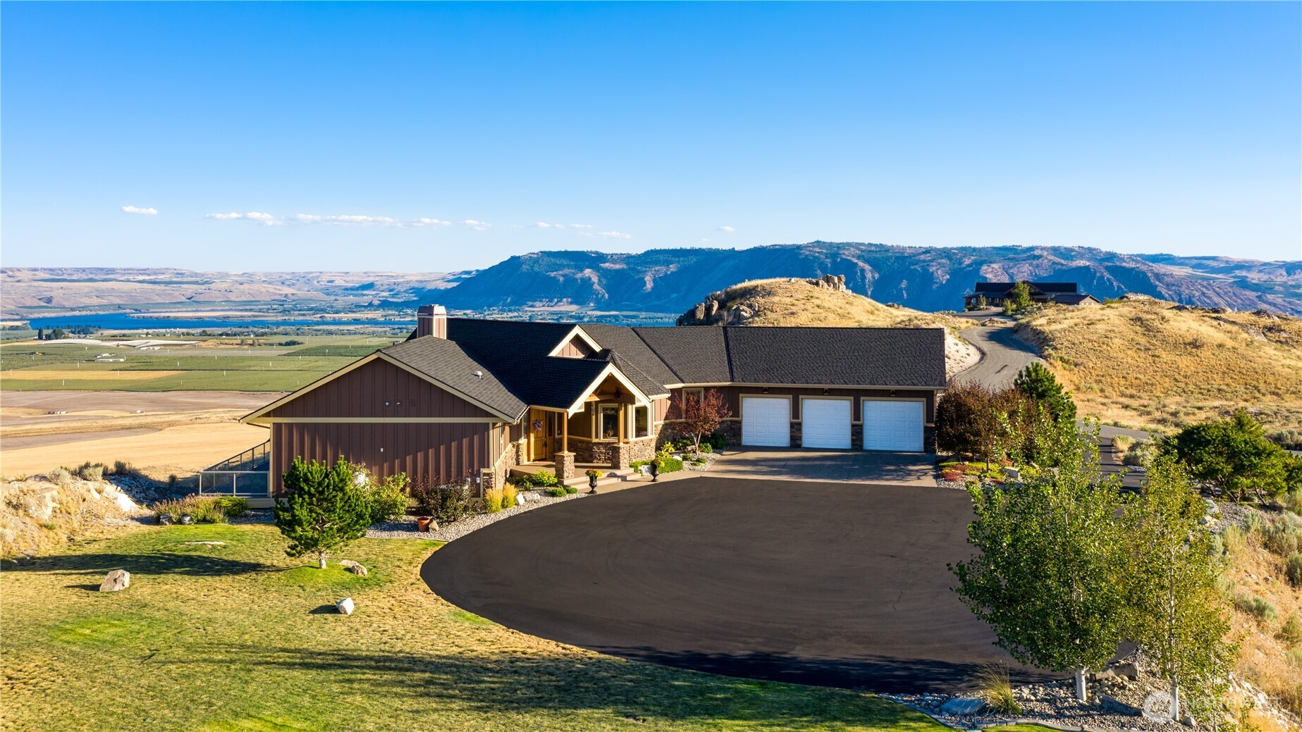 an aerial view of a house with a ocean view