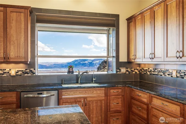 a kitchen with stainless steel appliances granite countertop a sink stove and cabinets