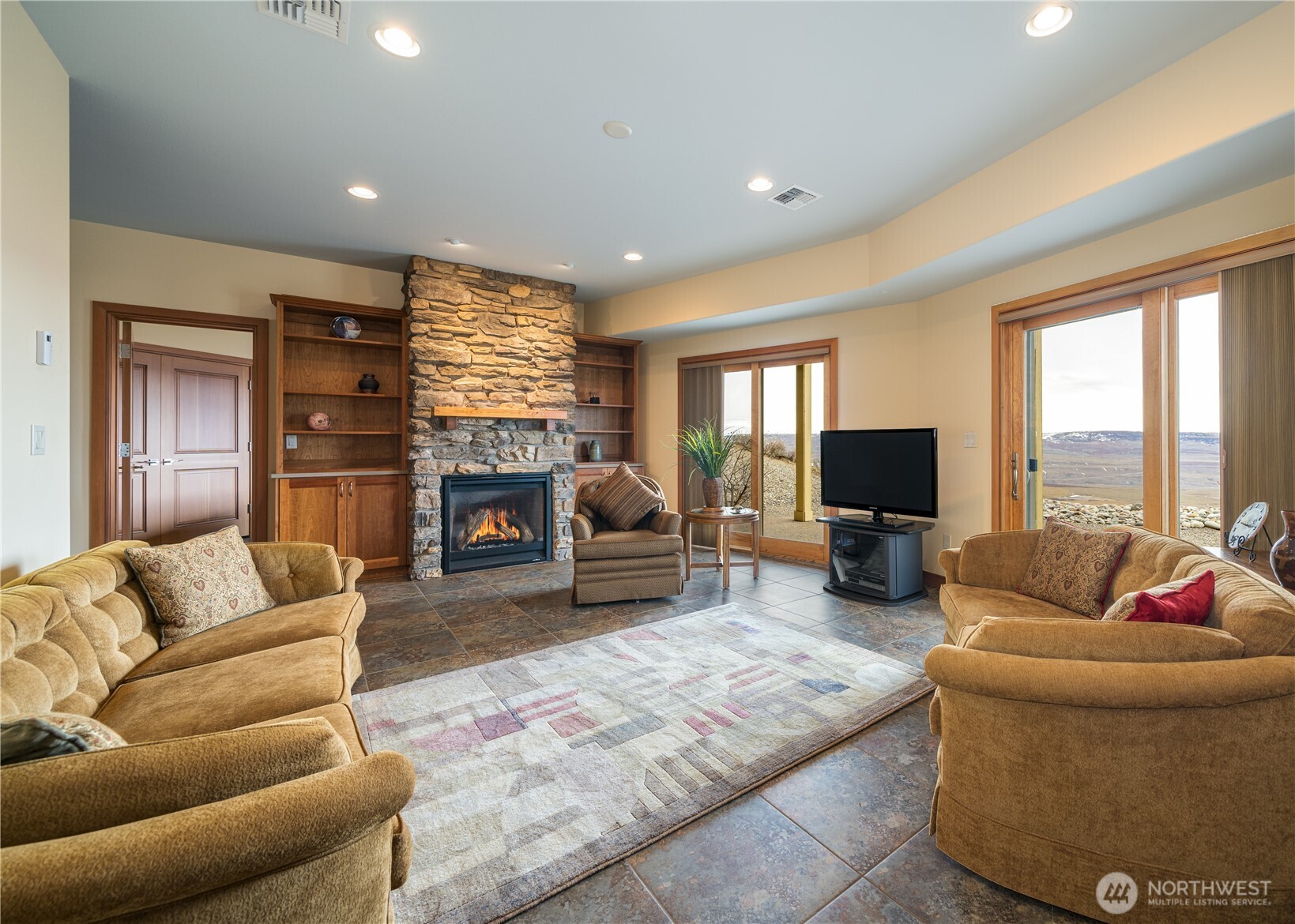 17 Vista Ridge Road Brewster, WA 98812 - Photo 17 of 40 a living room with furniture flat screen tv and a fireplace