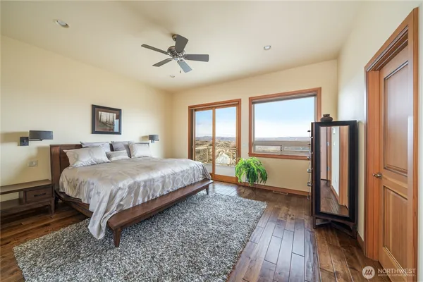 a spacious bedroom with a bed and a large window