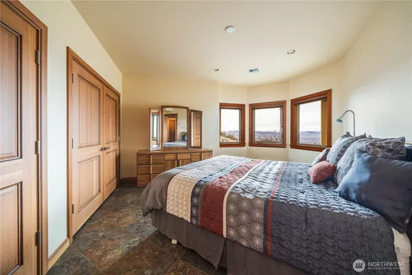 a bedroom with a large bed and a window