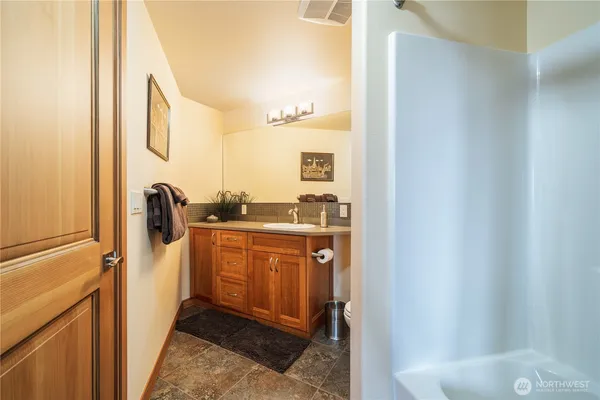 a bathroom with a sink a mirror and a shower