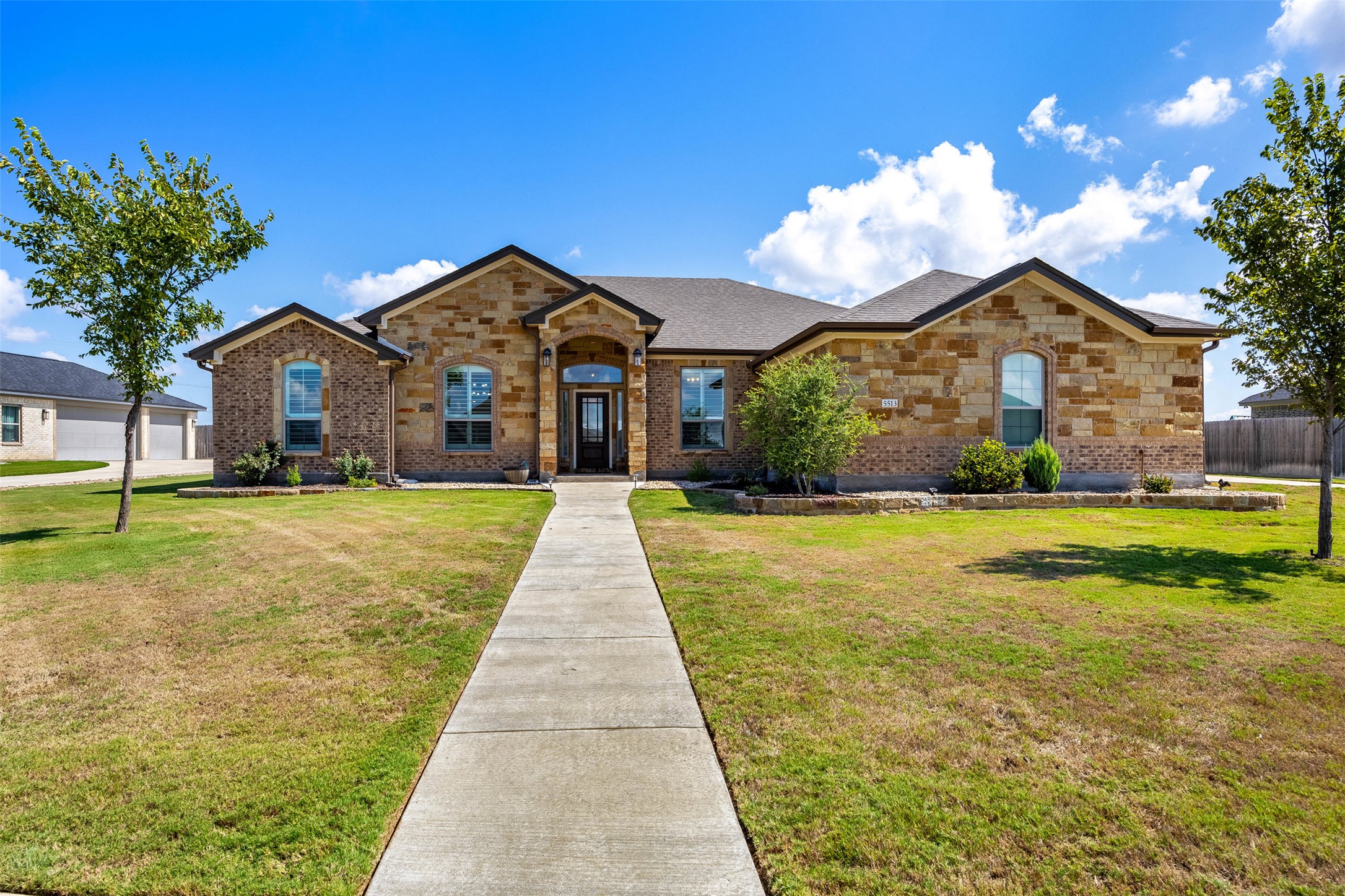 5513 Hollow Loop Salado, TX 76571 - Photo 1 of 1 View of front facade featuring brick siding and a front lawn
