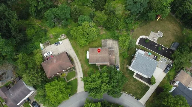 an aerial view of a house with a yard and lake view