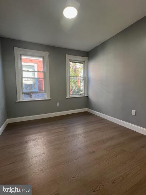 710 Main Street Darby, PA 19023 - Photo 16 of 20 an empty room with wooden floor and windows