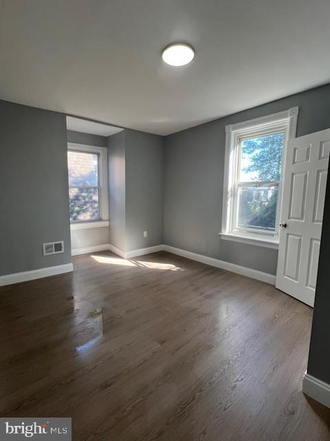 710 Main Street Darby, PA 19023 - Photo 17 of 20 an empty room with wooden floor and windows