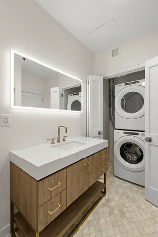 a utility room with sink dryer and washer