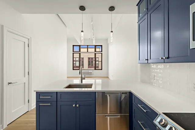a kitchen with a refrigerator and a sink
