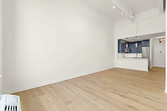 a view of a kitchen with a sink and a refrigerator