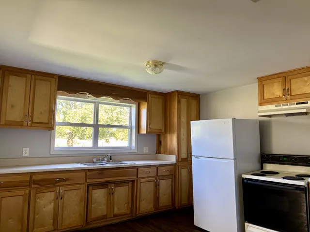 a kitchen with a refrigerator and a sink