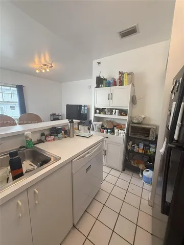 a kitchen with stainless steel appliances a sink and cabinets