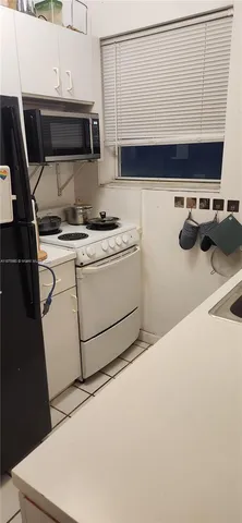a kitchen with a sink and a stove top oven