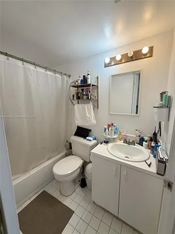 a bathroom with a sink mirror vanity and toilet