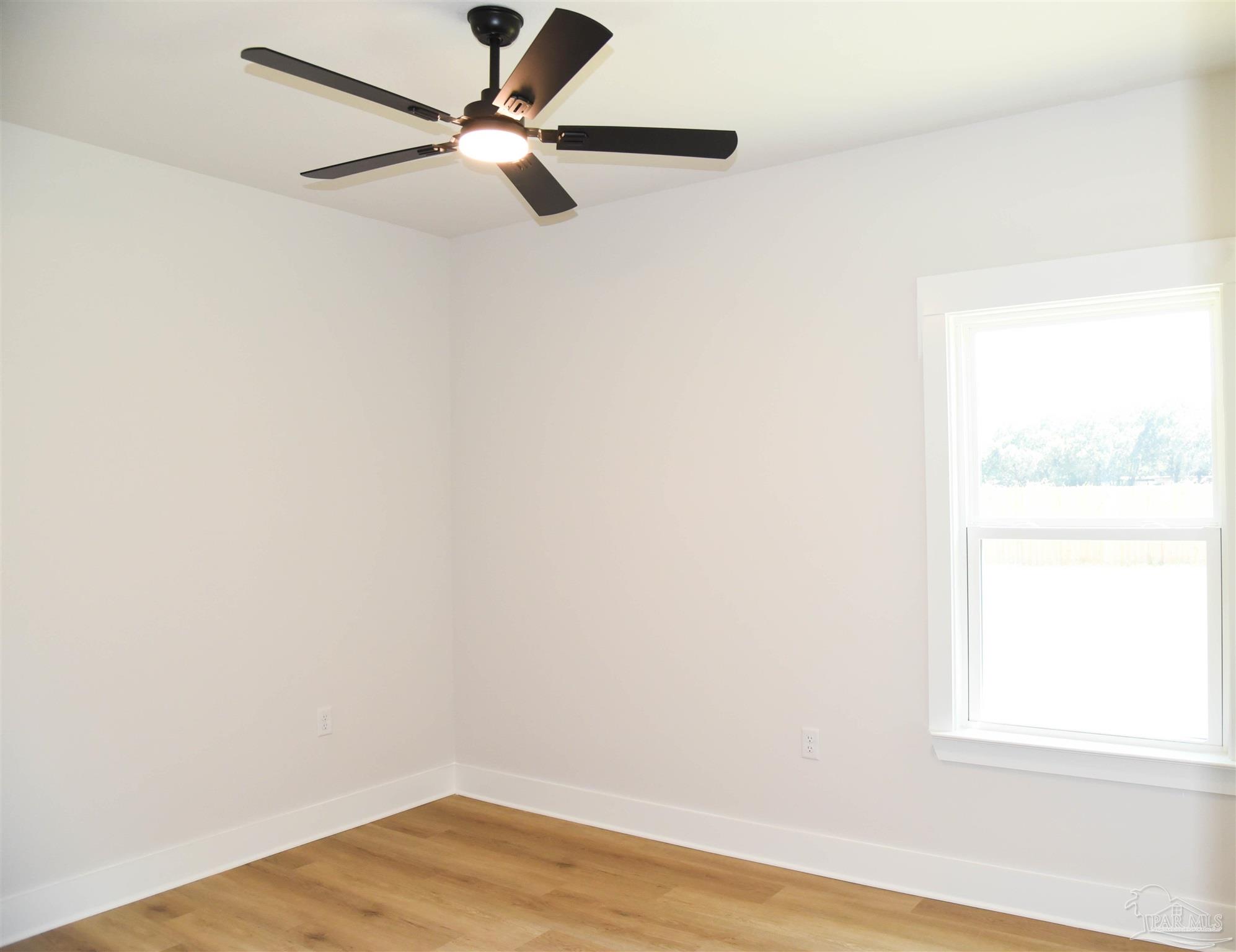 8080 Pinus Lane Pensacola, FL 32534 - Photo 13 of 25 an empty room with a window and a fan