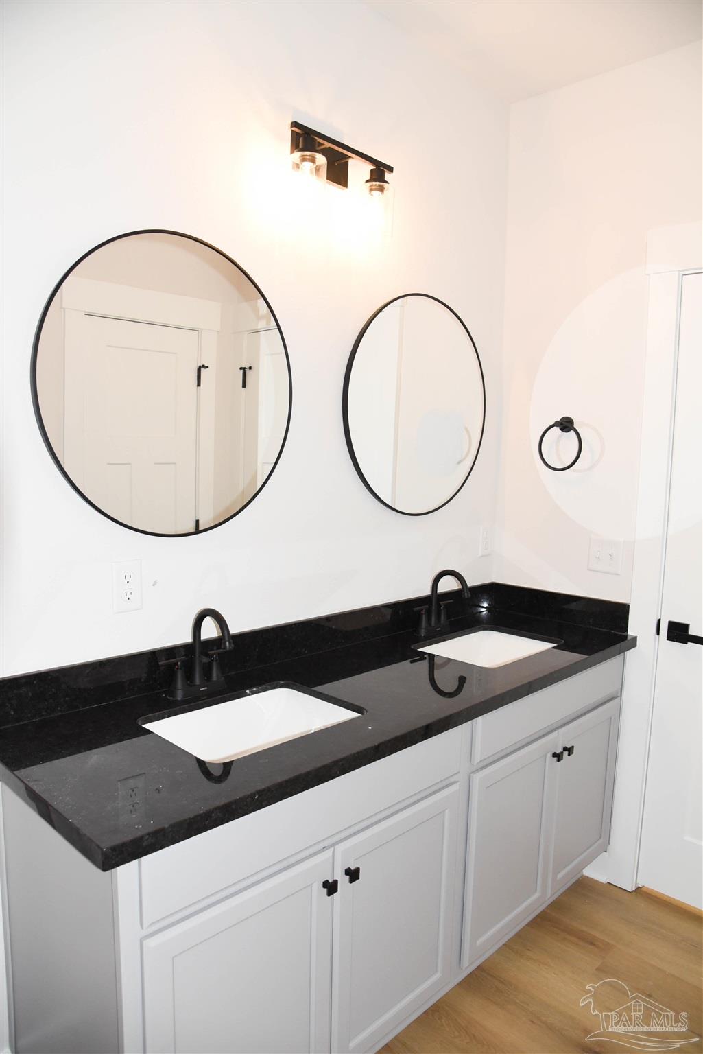 8080 Pinus Lane Pensacola, FL 32534 - Photo 14 of 25 a bathroom with a granite countertop sink and a mirror