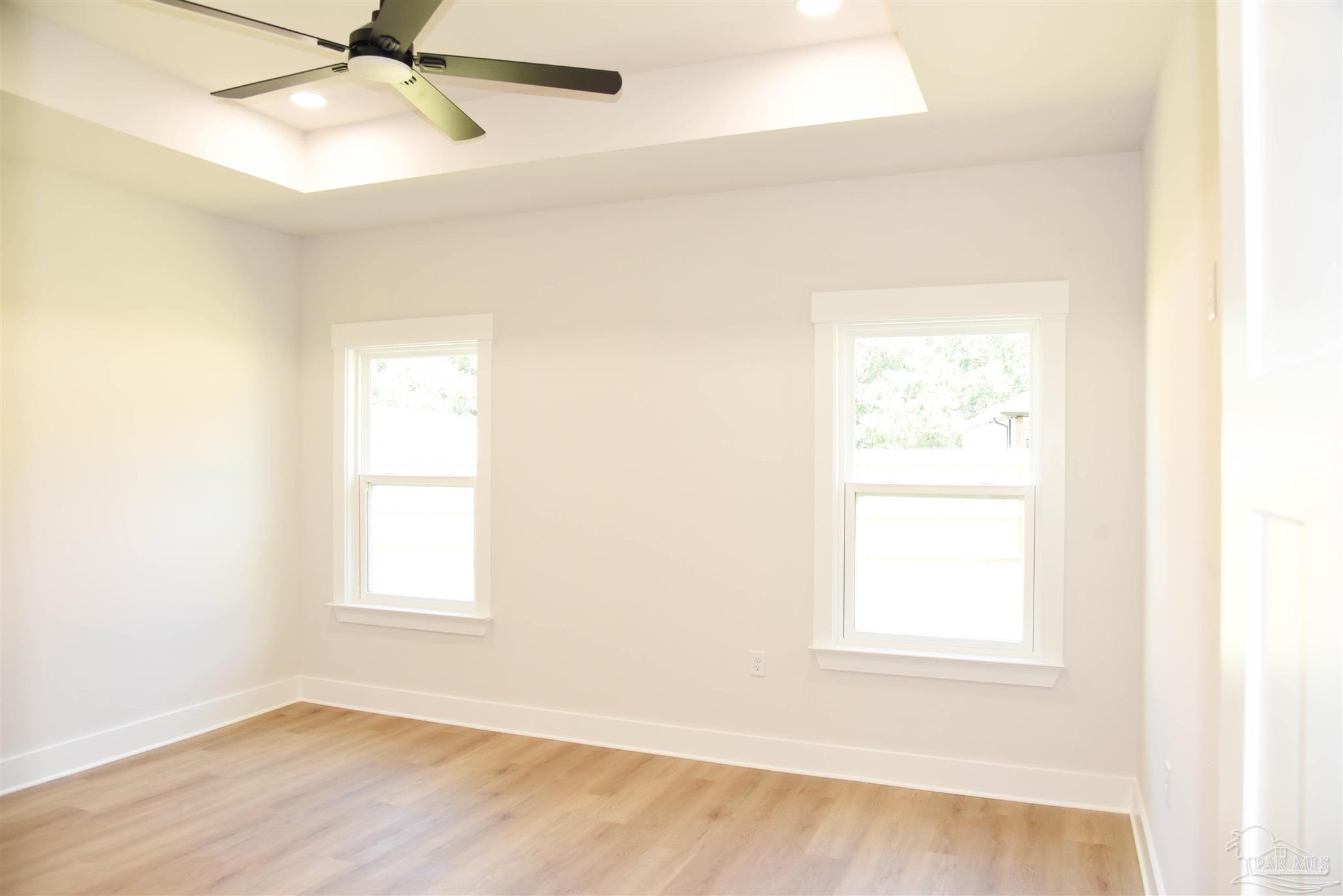 8080 Pinus Lane Pensacola, FL 32534 - Photo 15 of 25 an empty room with a window and a fan