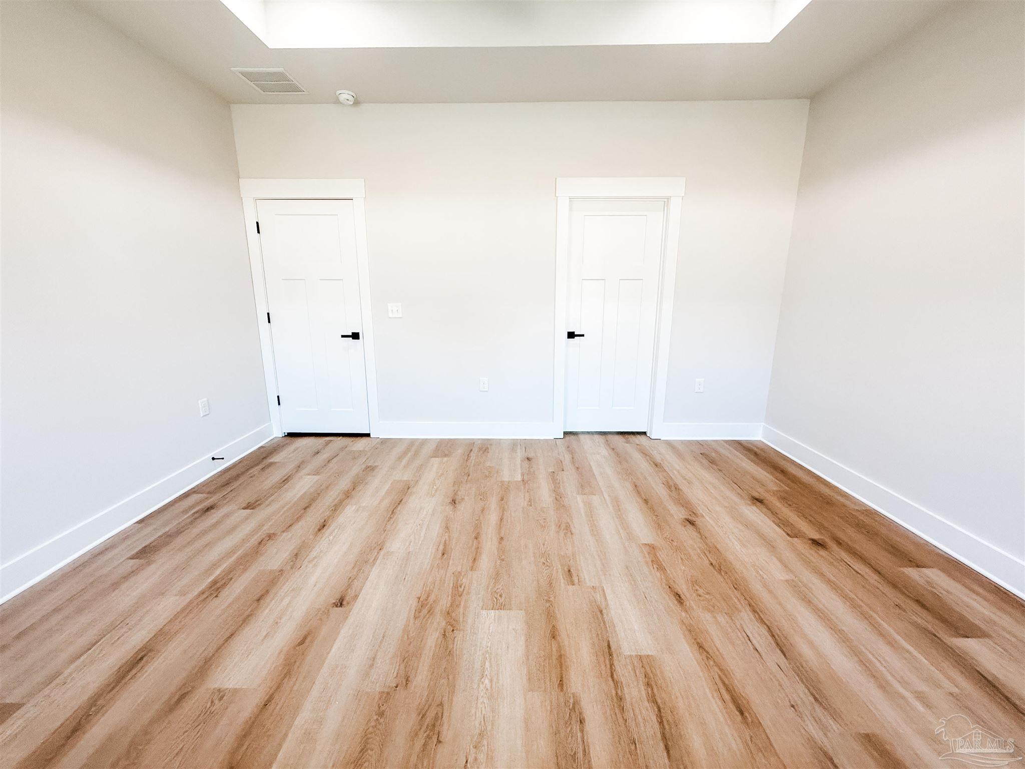 8080 Pinus Lane Pensacola, FL 32534 - Photo 16 of 25 a view of a room with wooden floor