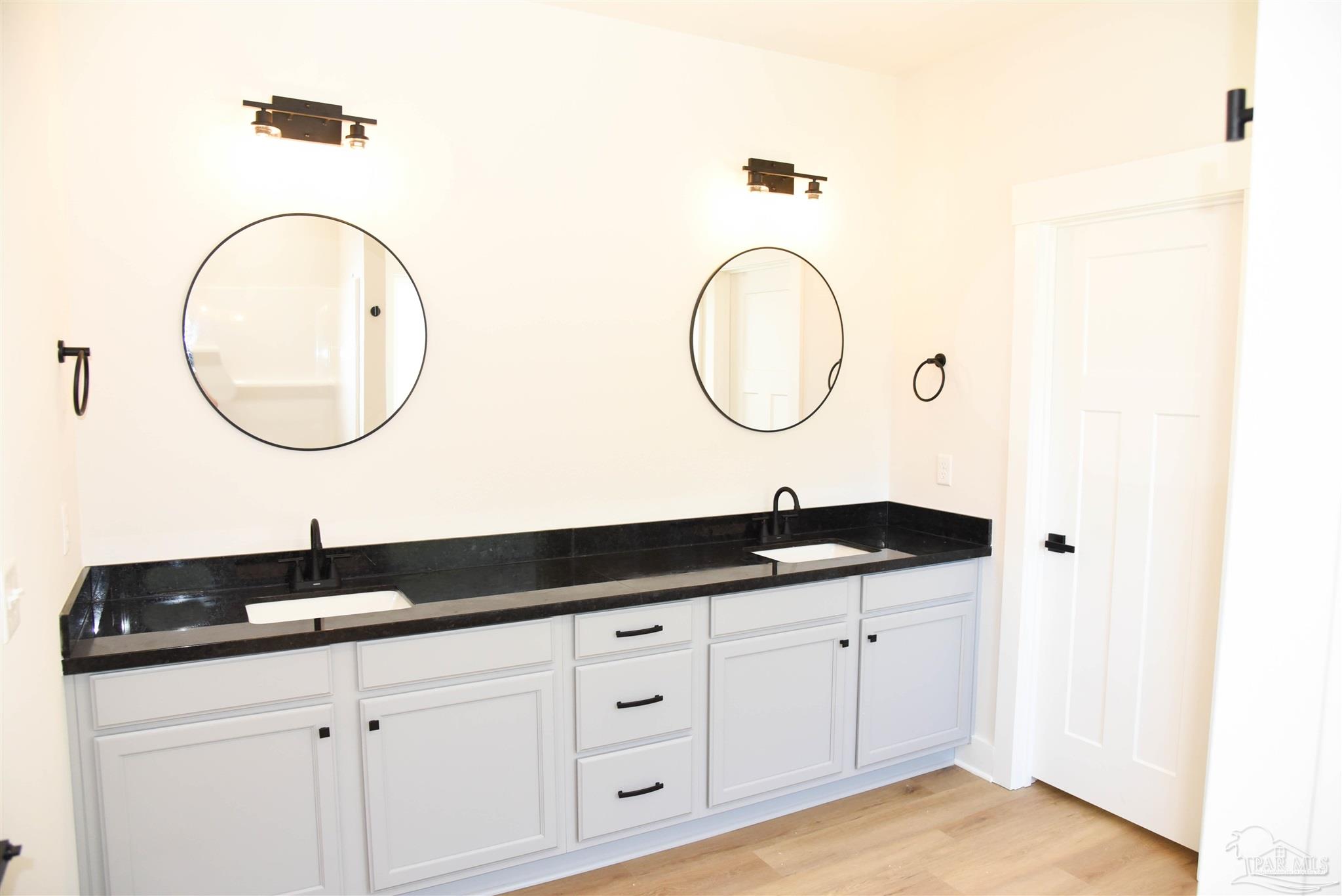 8080 Pinus Lane Pensacola, FL 32534 - Photo 17 of 25 a bathroom with a sink and a mirror