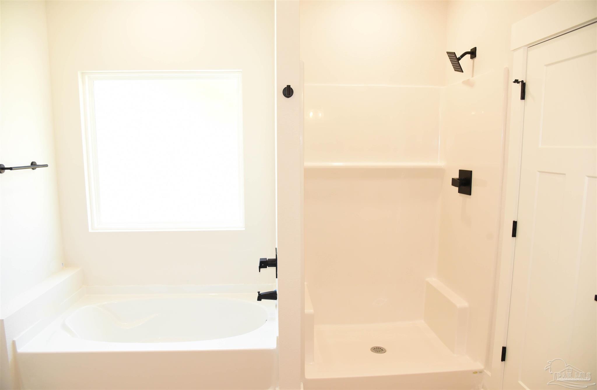 8080 Pinus Lane Pensacola, FL 32534 - Photo 18 of 25 a bathroom with a bathtub
