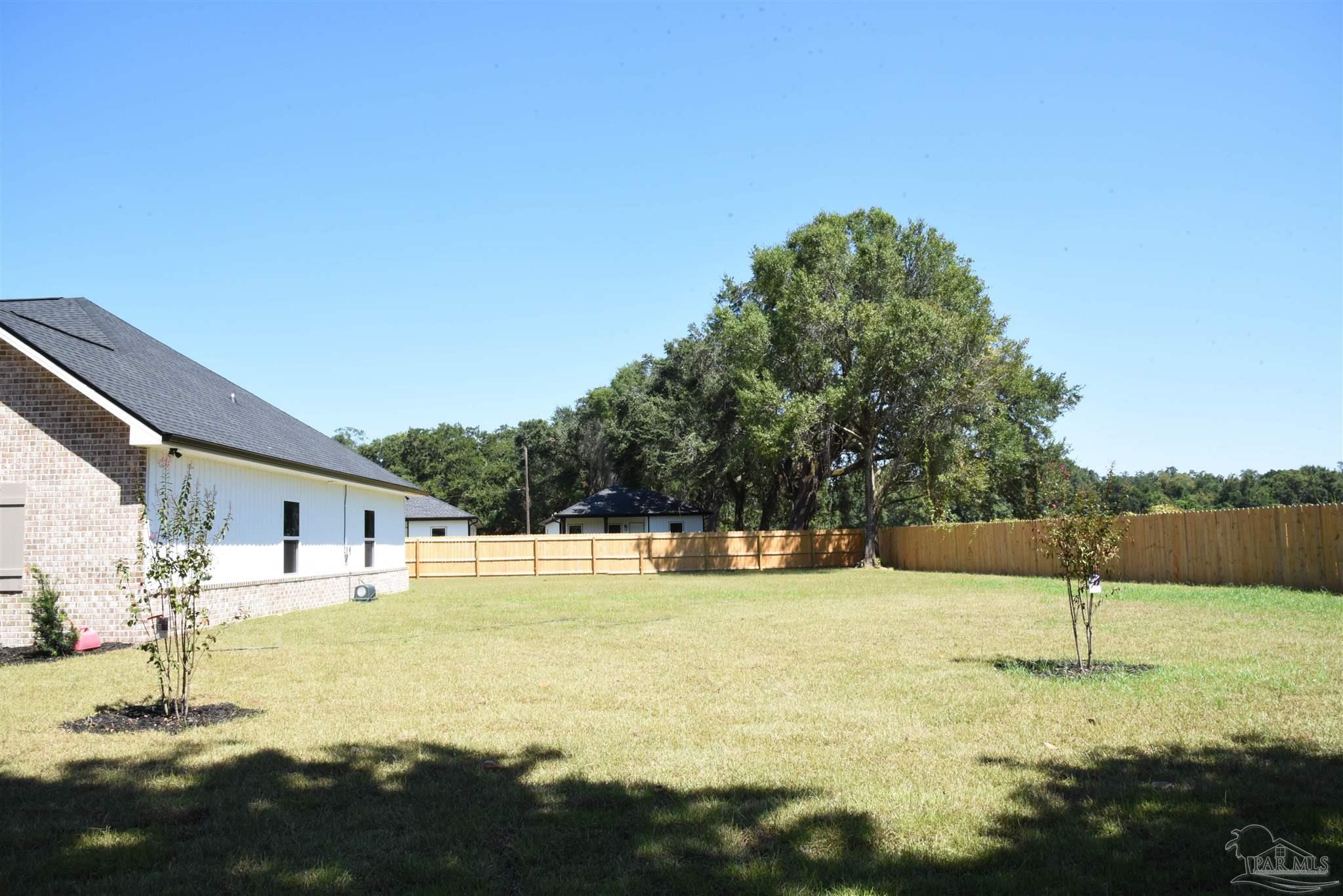 8080 Pinus Lane Pensacola, FL 32534 - Photo 24 of 25 a swimming pool with some trees in the background