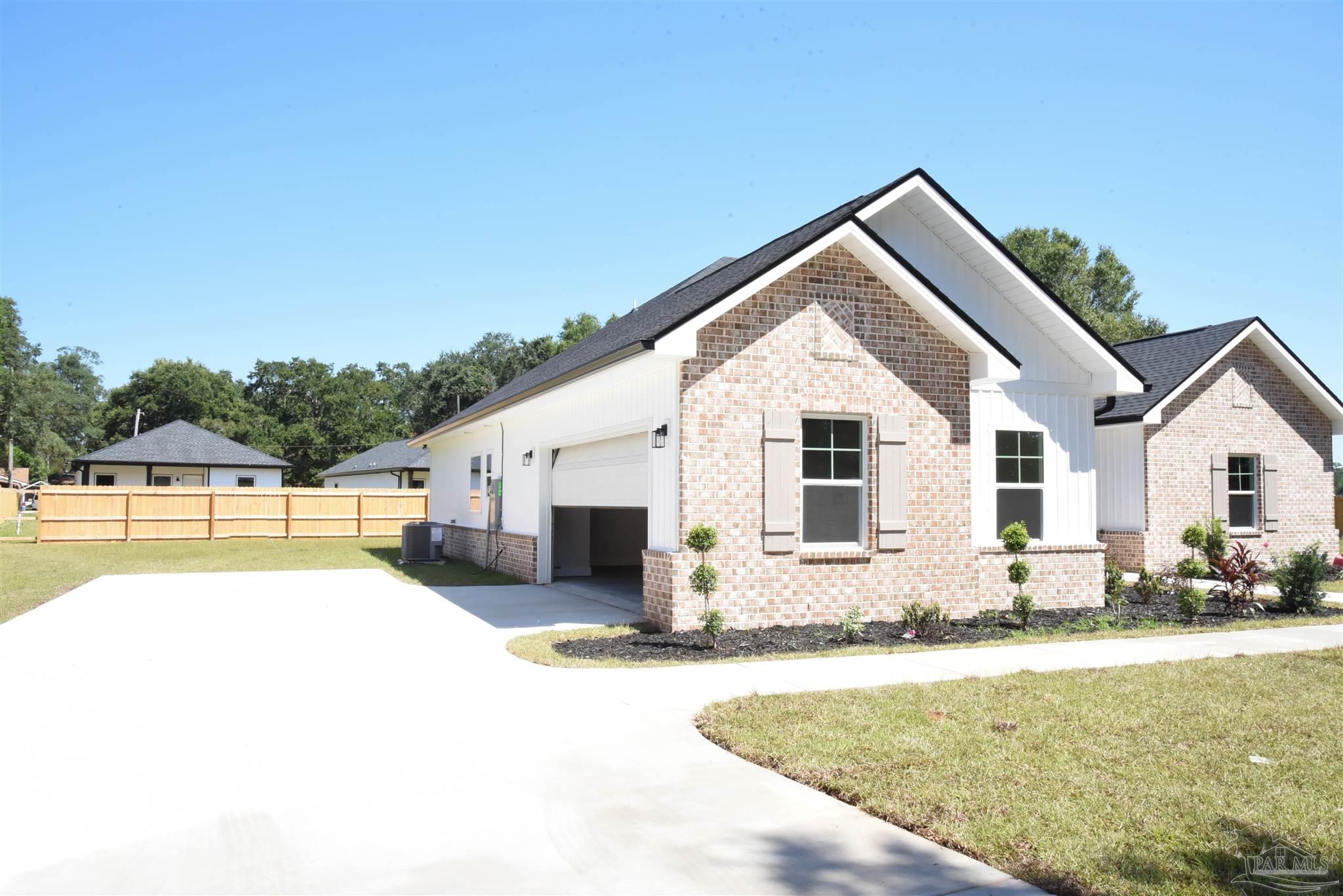8080 Pinus Lane Pensacola, FL 32534 - Photo 25 of 25 a view of a white house with a swimming pool