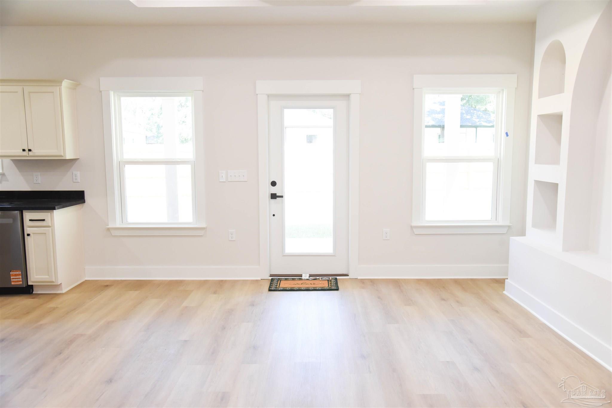 8080 Pinus Lane Pensacola, FL 32534 - Photo 7 of 25 an empty room with wooden floor and windows