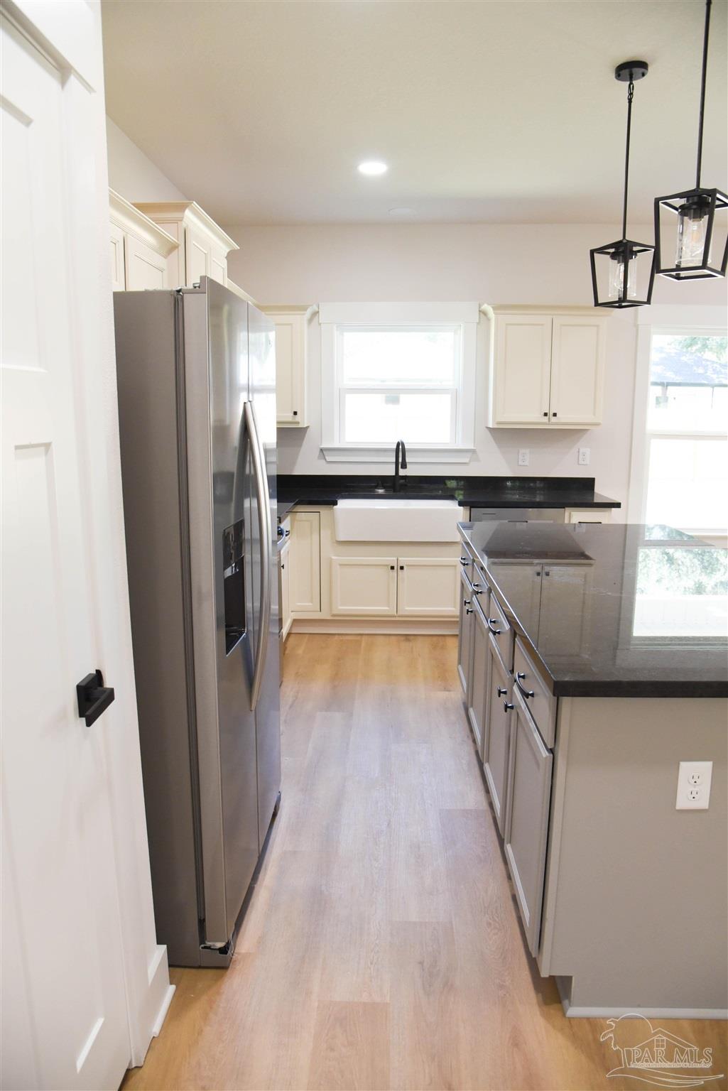 8080 Pinus Lane Pensacola, FL 32534 - Photo 9 of 25 a kitchen with stainless steel appliances granite countertop a refrigerator a sink and a stove
