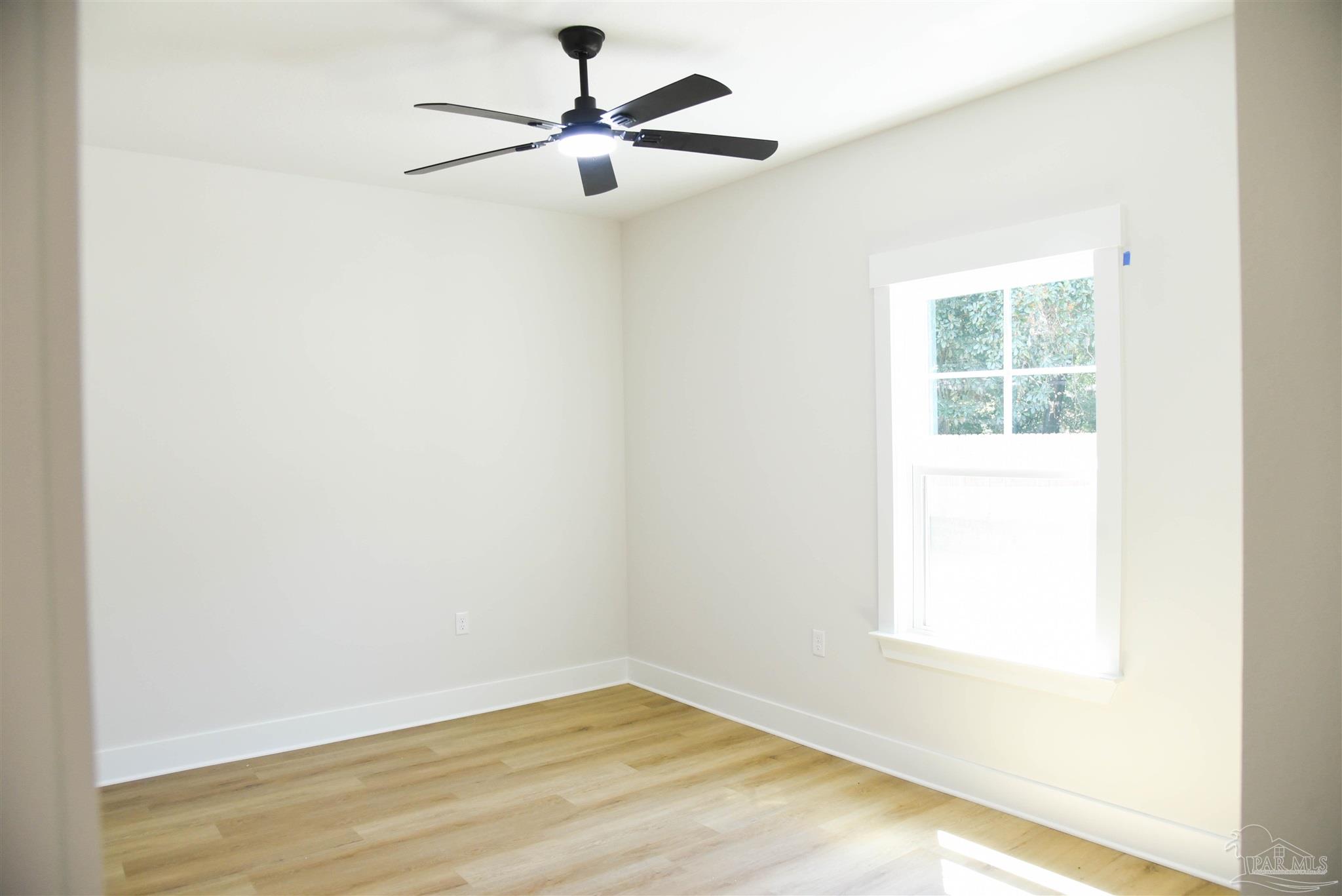 8080 Pinus Lane Pensacola, FL 32534 - Photo 10 of 25 an empty room with a window and a ceiling fan