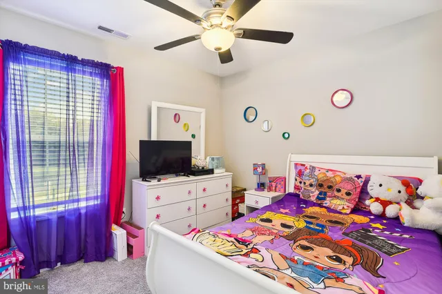 a living room with flat screen tv and a couch
