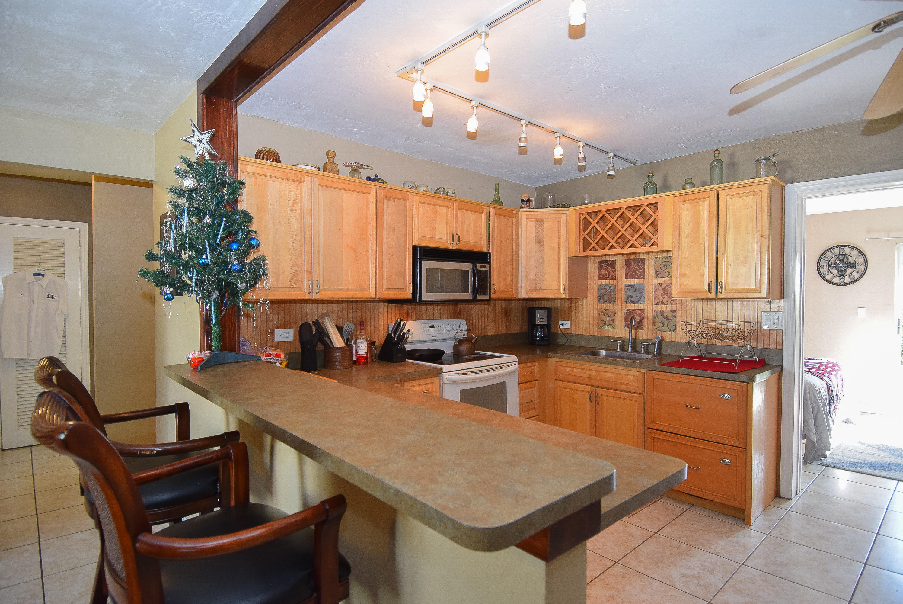 338 3rd Road Key Largo, FL 33037 - Photo 2 of 23 a kitchen with a table chairs sink and microwave