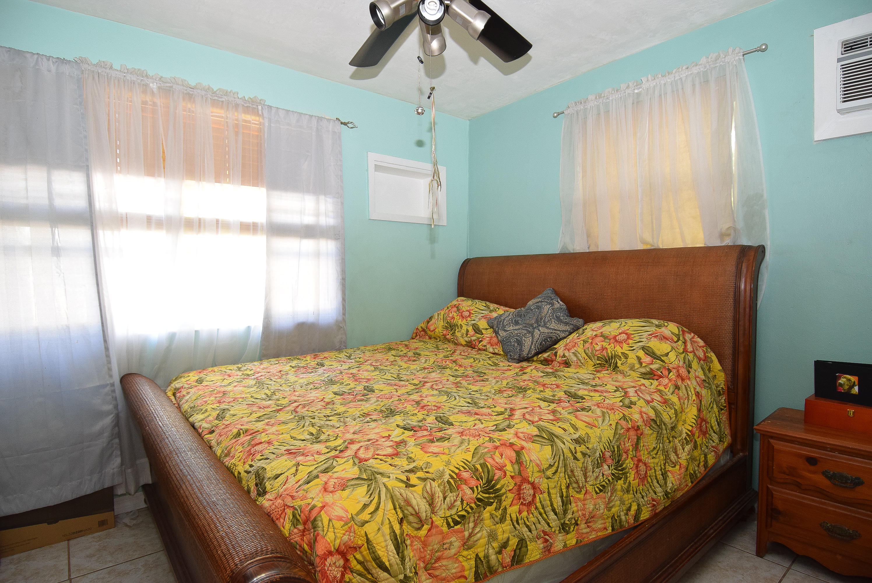 338 3rd Road Key Largo, FL 33037 - Photo 13 of 23 a bed sitting in a bedroom next to a window
