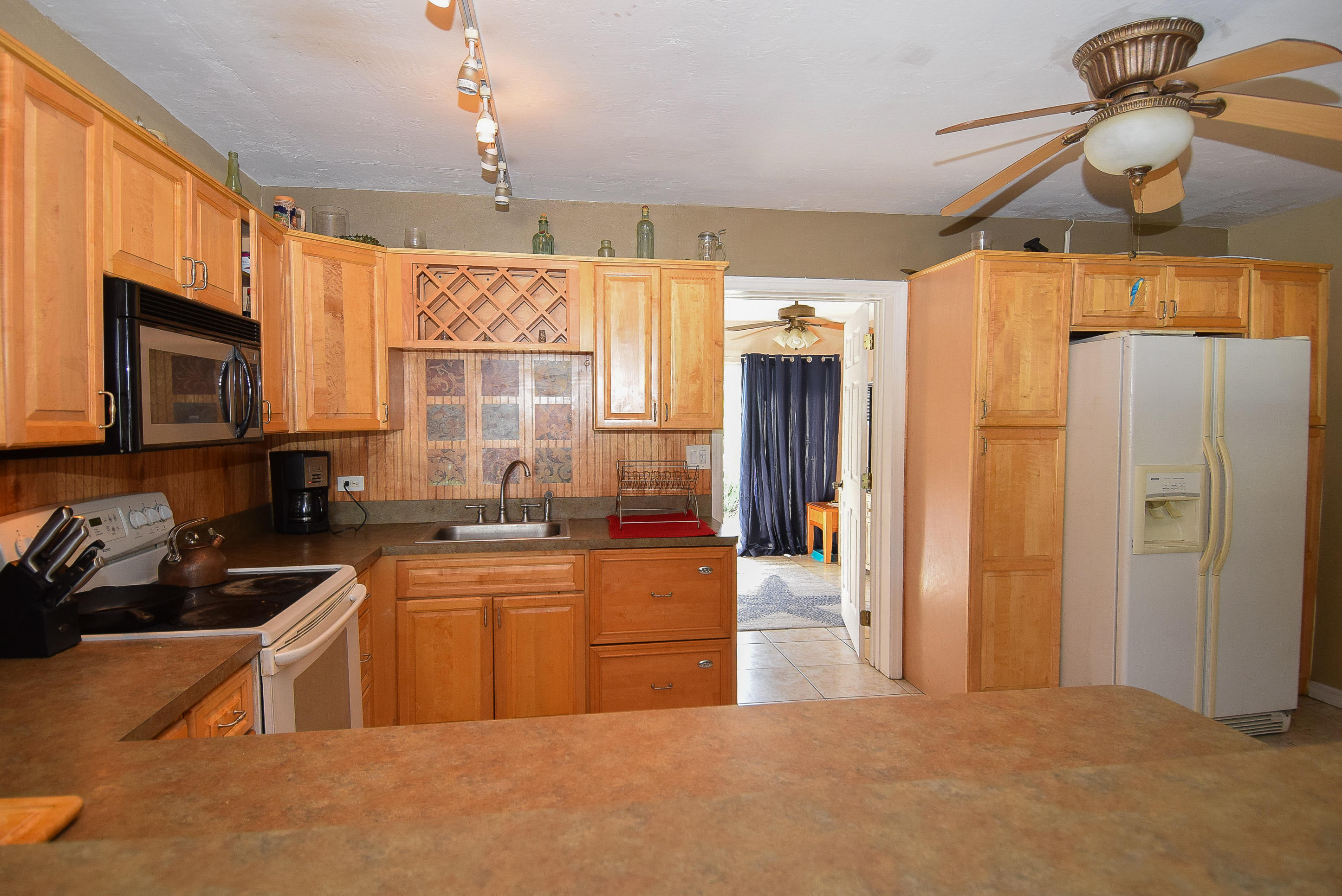 338 3rd Road Key Largo, FL 33037 - Photo 9 of 23 a kitchen with stainless steel appliances granite countertop a sink a stove and a refrigerator