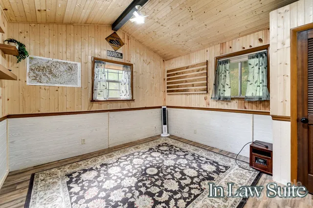 a view of a backyard with table and chairs and wooden fence